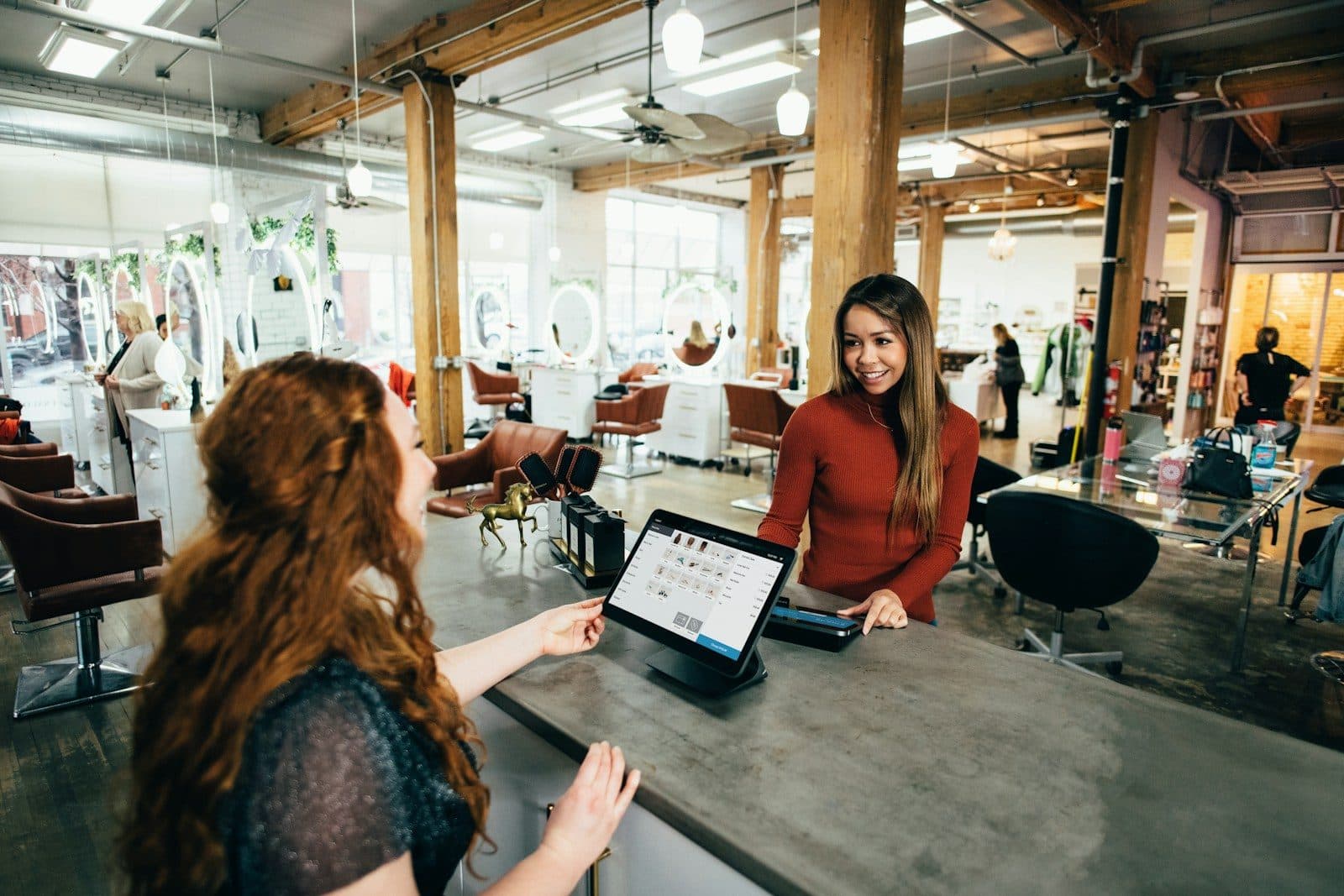 A customer checking in at the front desk of a salon